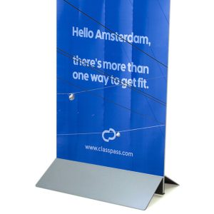 A freestanding rigid display stand with a sloped base, supporting a large vertical panel.