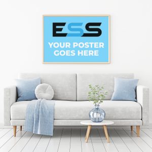 A framed poster hanging above a light grey sofa with blue pillows and a white fluffy cushion, featuring the text "ESS YOUR POSTER GOES HERE" on a blue background.