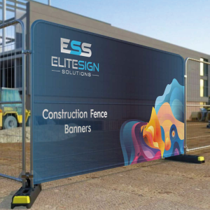 A large outdoor construction fence banner with colourful abstract artwork on a dark background.
