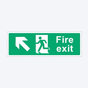 A green rectangular fire exit sign with white symbols and text. On the left, there is a white arrow pointing diagonally upward to the left. In the center, there is a white pictogram of a person running towards a door with an upward arrow. To the right, the sign reads "Fire exit" in white bold letters.