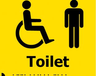 A yellow square sign showing a black icon of a person in a wheelchair and a standing person, with the word "Toilet" in bold black letters below, along with Braille dots beneath.