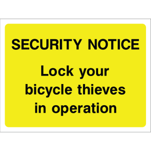 Outdoor warning sign with black text on yellow background: "Lock your bicycle thieves in operation"