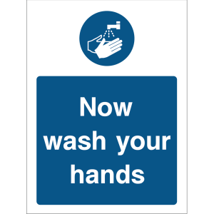 Warning sign with a blue background, white text “Now wash your hands,” and an icon of hands under running water at the top
