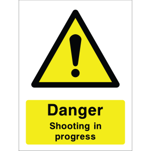 Warning sign with a yellow triangle containing an exclamation mark and the words “Danger Shooting in progress” in bold black on yellow background