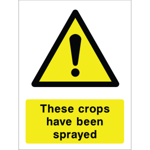 Warning sign with a yellow triangle containing an exclamation mark and the words “These crops have been sprayed” in bold black on yellow background