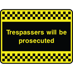 Outdoor warning sign with checkered border and text: "Trespassers will be prosecuted"