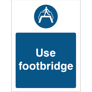 Warning sign with a blue background, white text “Use footbridge,” and an icon of a person walking on a footbridge at the top