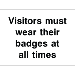 Outdoor warning sign with bold black text: "Visitors must wear their badges at all times"