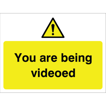 Outdoor warning sign with exclamation icon and message "You are being videoed" in black on yellow background