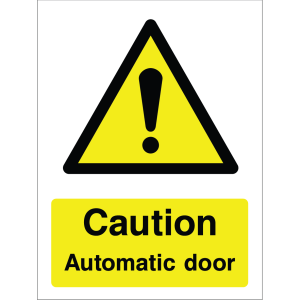 Warning sign showing a black exclamation mark inside a triangle and the message: "Caution. Automatic door." on yellow background, used to alert about automatic door safety hazards.