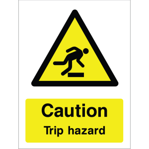Warning sign showing a black triangle icon with a person tripping and the message: "Caution. Trip hazard." on yellow background, used to alert about trip hazards.