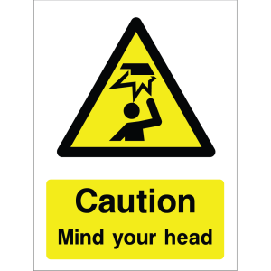 Warning sign showing a black triangle icon with a person hitting their head and the message: "Caution. Mind your head." on yellow background, used to alert about overhead head injury risks.