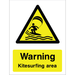 Warning sign showing a kitesurfer icon inside a yellow triangle and the message: "Warning Kitesurfing area" on a yellow background, used to alert water users to kitesurfing hazards.